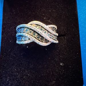 1/10 ctw of a Genuine treated Blue w/ White Diamond Accent Ring